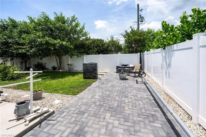Fenced backyard with a patio area and outdoor dining space