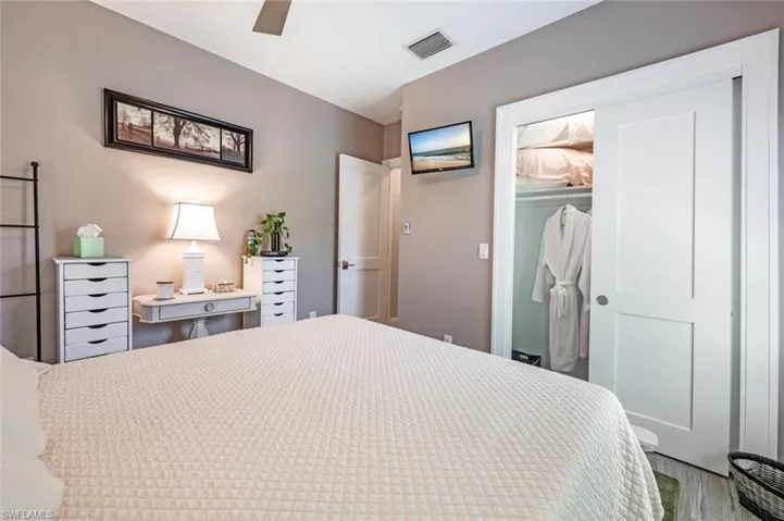 Bedroom with wood finished floors, ceiling fan, and a closet