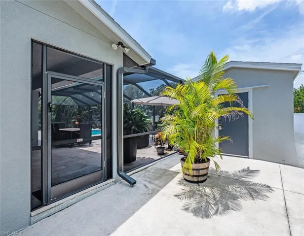 View of patio featuring a lanai