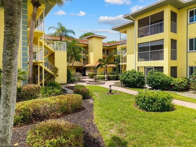 View of property's community with a lawn