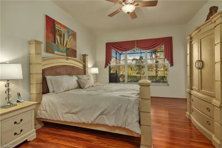 Bedroom with ceiling fan and dark wood-type flooring