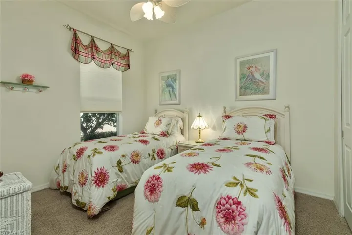 Carpeted bedroom with ceiling fan