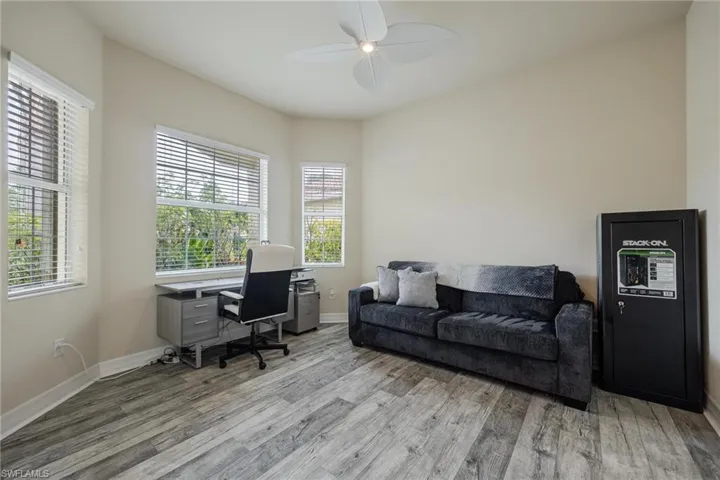Office area featuring wood-type flooring and ceiling fan