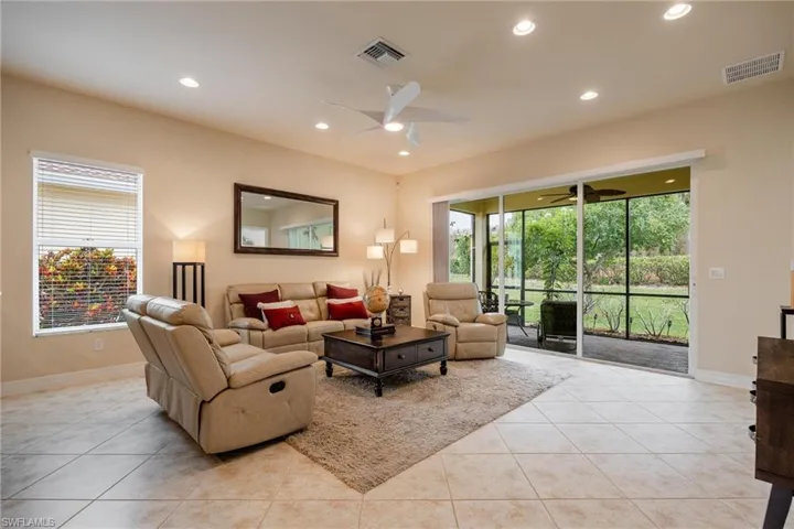 Tiled living room featuring ceiling fan