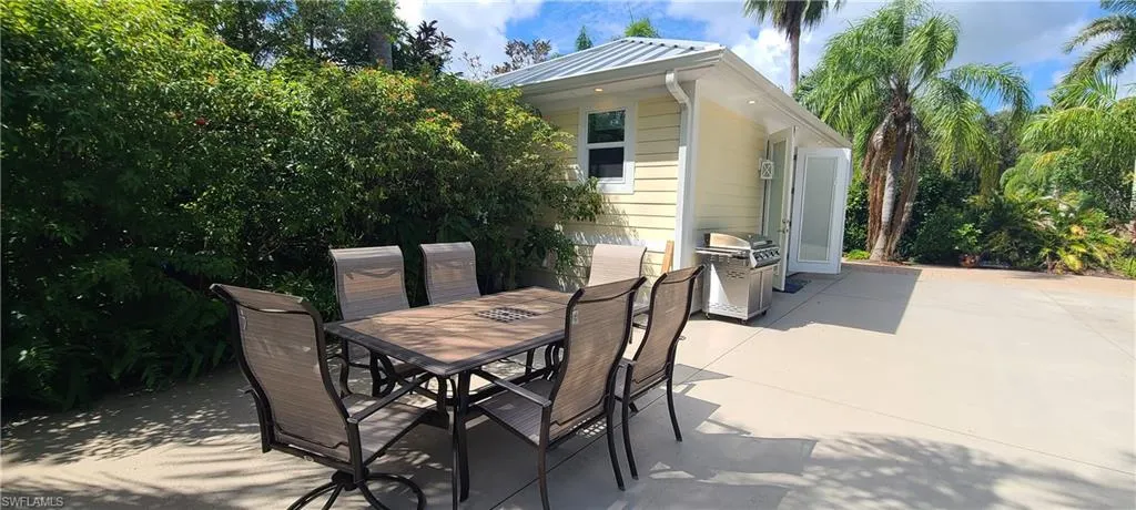 View of patio featuring outdoor dining space and grilling area