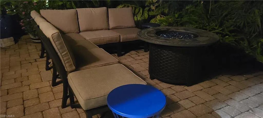 View of patio with an outdoor living space with a fire pit