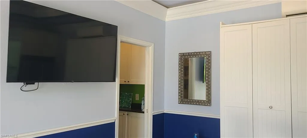 Hallway featuring crown molding and a wall unit AC