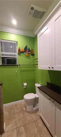 Bathroom featuring vanity, light tile patterned floors, and recessed lighting