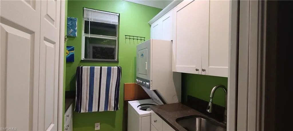 Laundry area with estacked washer and dryer and cabinet space