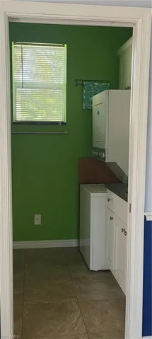 Washroom with cabinet space and estacked washer and dryer