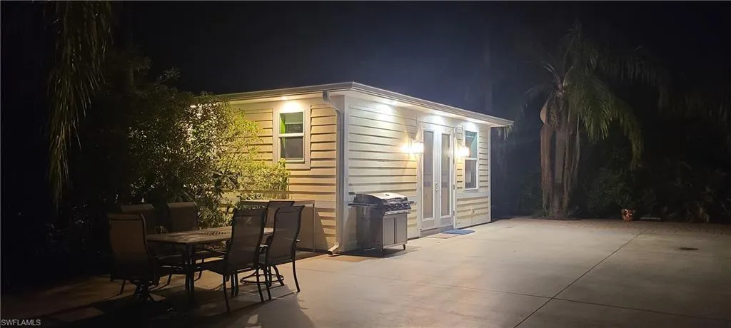View of coach house with outdoor dining space