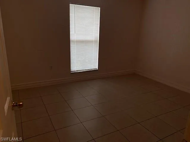 Unfurnished room featuring tile patterned floors