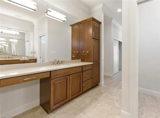 Spacious bathroom featuring a double vanity with ample counter space, built-in cabinetry, and a dedicated makeup area