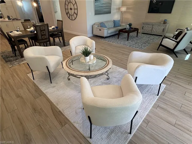 Living room featuring light wood-style flooring and baseboards