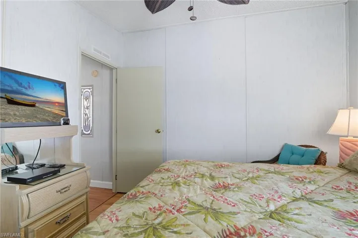 Bedroom with light wood-style floors and a ceiling fan