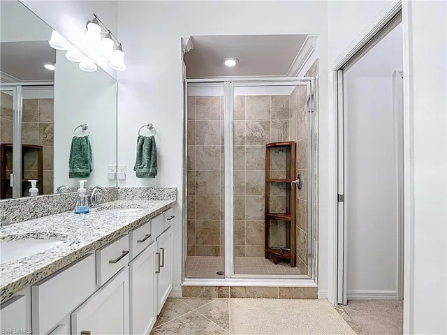 Bathroom with a stall shower and light tile patterned floors