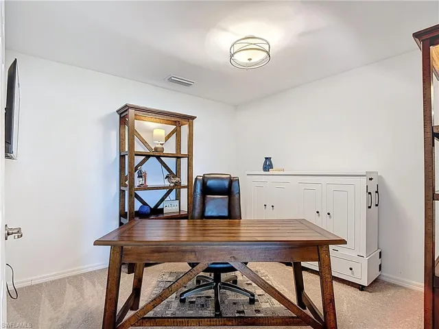Office space featuring light colored carpet