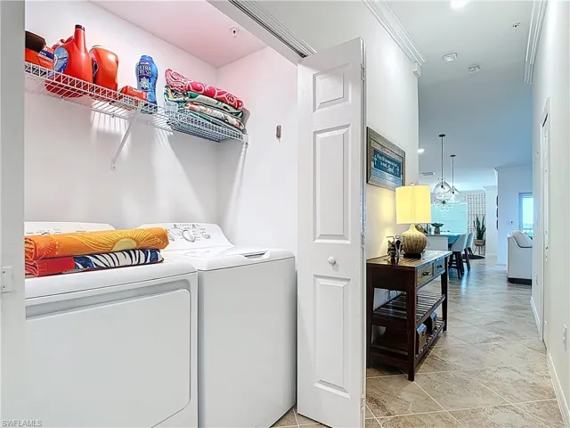 Washroom featuring separate washer and dryer, recessed lighting, and light tile patterned flooring