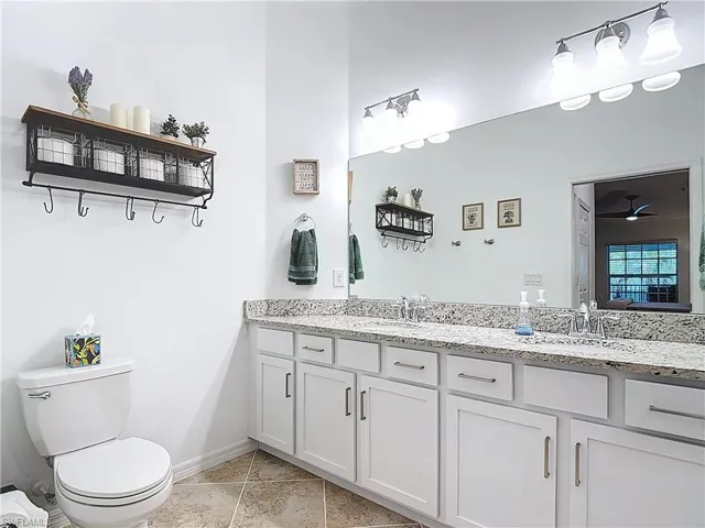 Bathroom featuring toilet and light tile patterned flooring