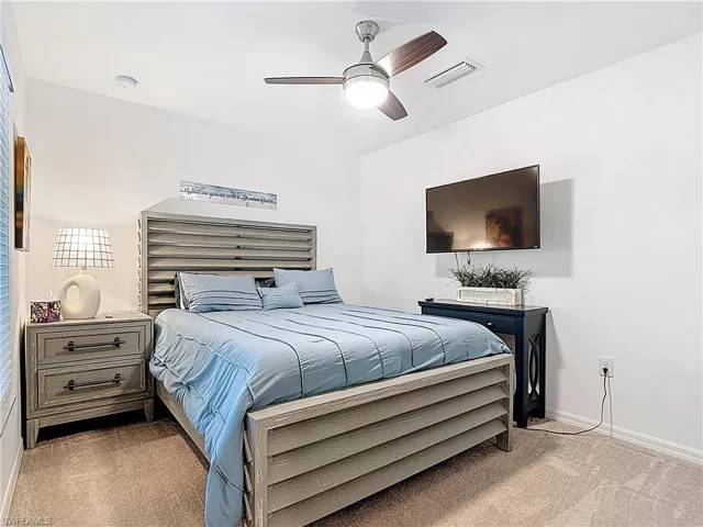 Bedroom with carpet flooring and a ceiling fan