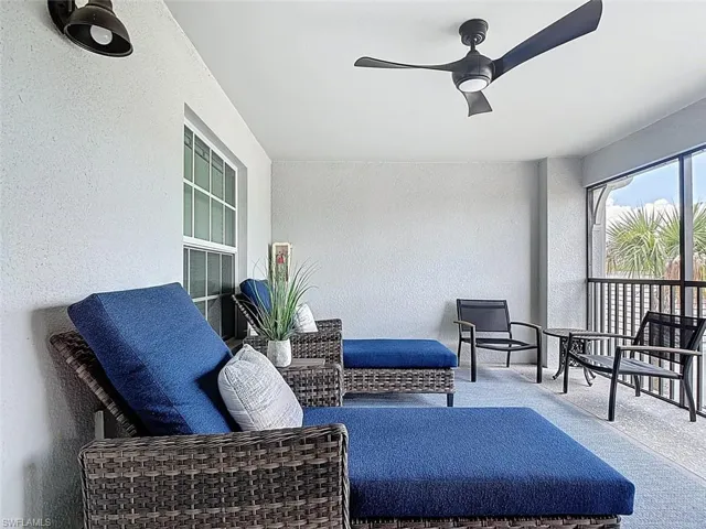 Sunroom / solarium featuring a textured wall and carpet flooring