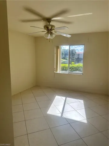 Unfurnished room with light tile patterned floors and a ceiling fan