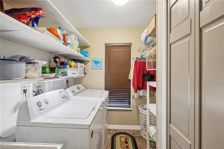 Clothes washing area featuring washer and clothes dryer, electric dryer hookup, and washer hookup