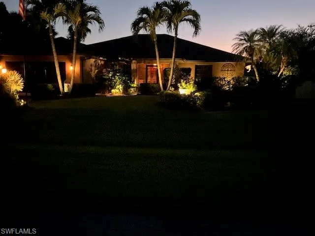 Ranch-style home featuring a lawn