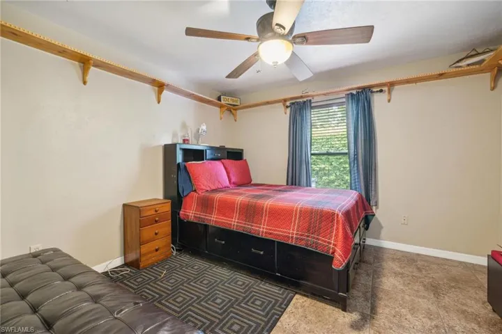 Bedroom featuring tile flooring and ceiling fan