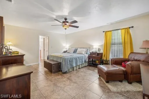 Bedroom featuring tile floors and ceiling fan