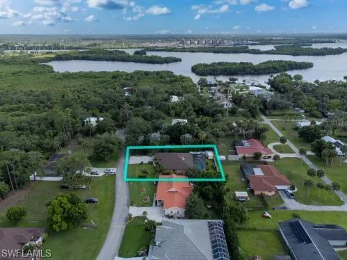 Birds eye view of property with a water view