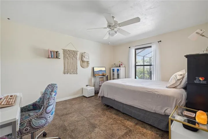 Bedroom featuring tile floors and ceiling fan