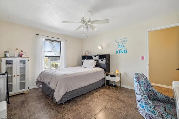 Bedroom with ceiling fan and tile flooring