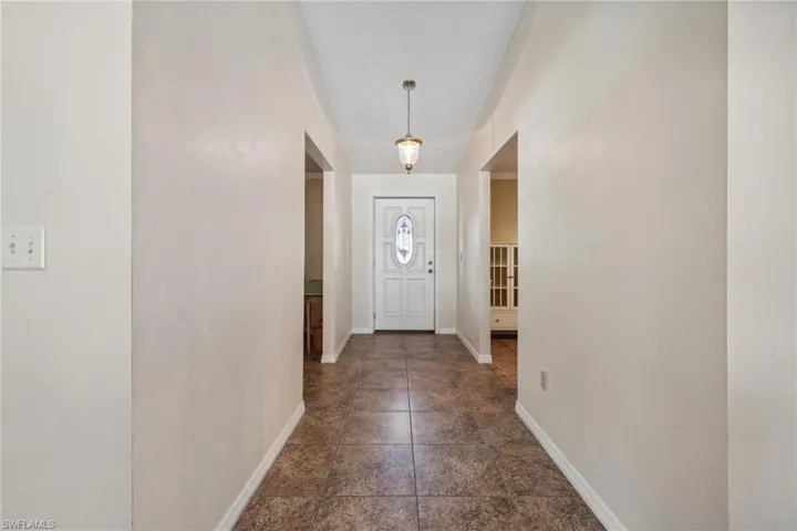 Doorway featuring dark tile floors
