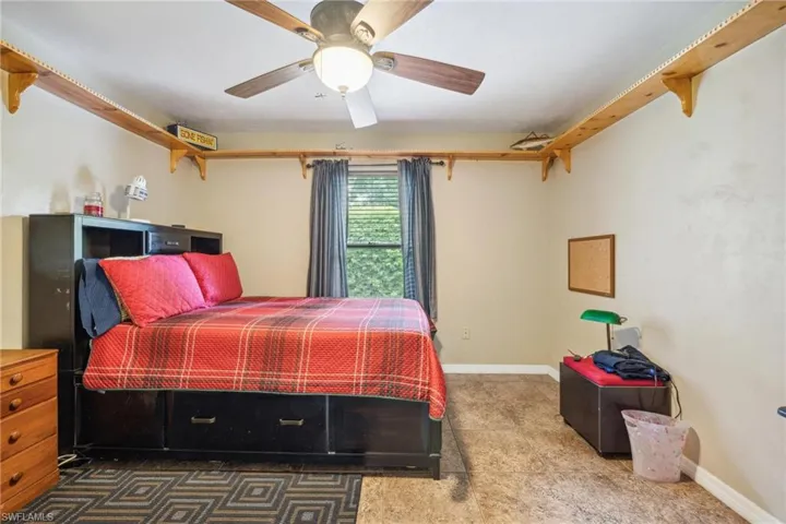 Bedroom featuring ceiling fan and tile floors