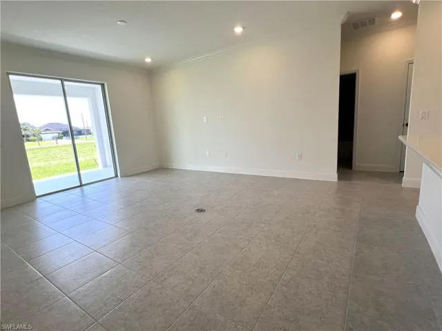Spare room with ornamental molding, recessed lighting, and light tile patterned flooring