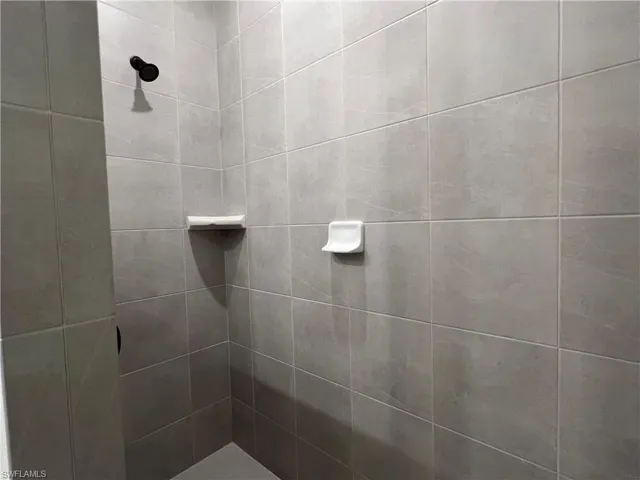 Full bath with a tile shower