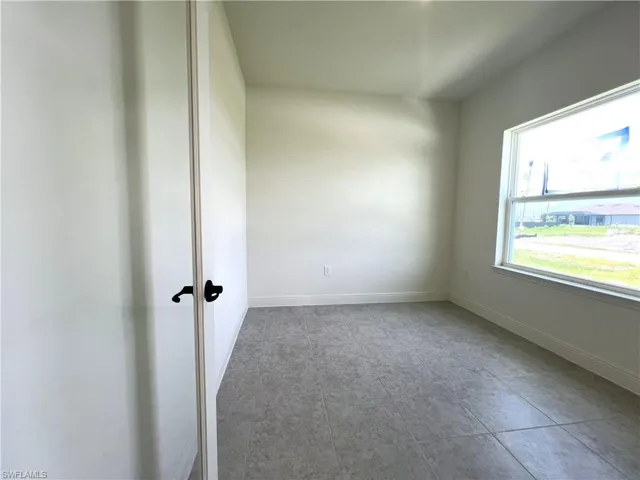 Spare room featuring baseboards