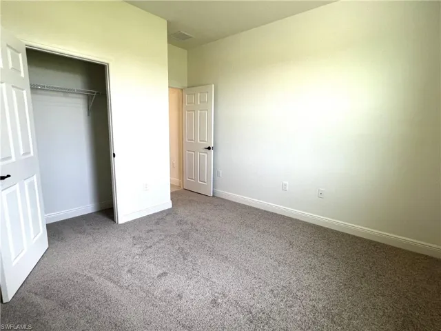 Unfurnished bedroom with carpet floors and a closet