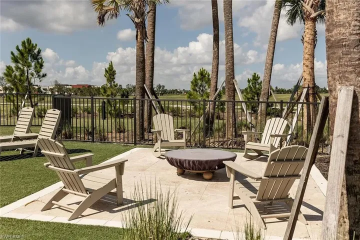 Outdoor patio featuring a stone-look paver surface, surrounded by manicured lawn