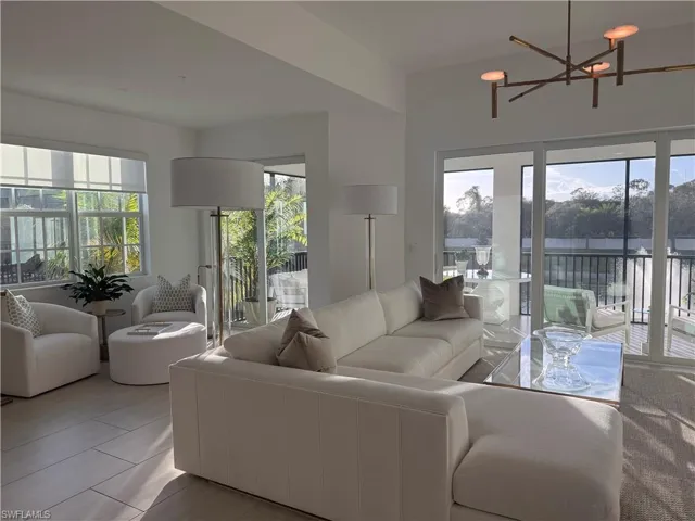 Living area featuring healthy amount of natural light and a chandelier