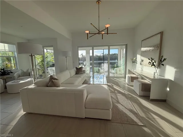 Living area with healthy amount of natural light and a chandelier