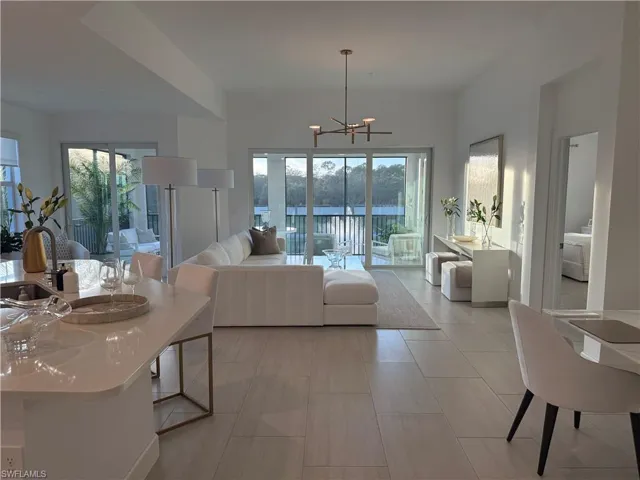 Living room featuring a chandelier and healthy amount of natural light