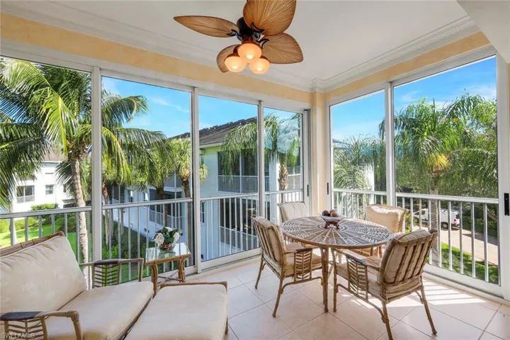 Screened lanai featuring tile flooring and a ceiling fan with integrated lighting