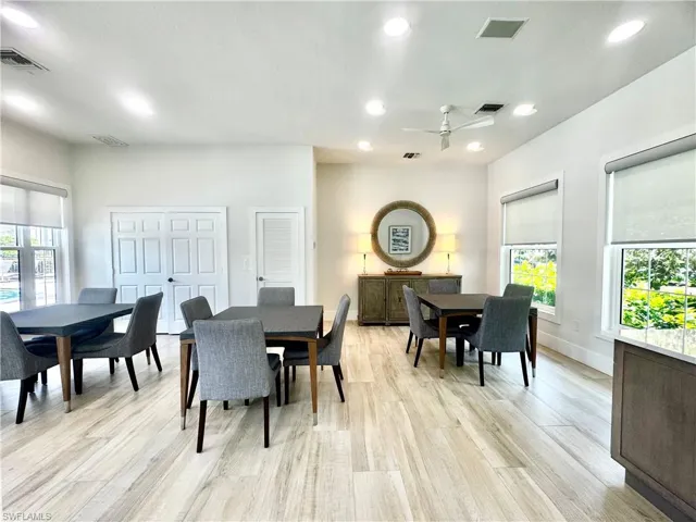 Spacious common room featuring wood-finish flooring, recessed lighting, and a ceiling fan