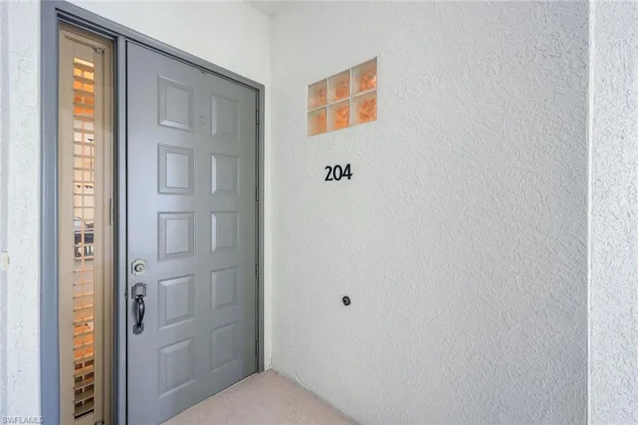Panel-style entry door with a sidelight window, featuring a matte black door handle