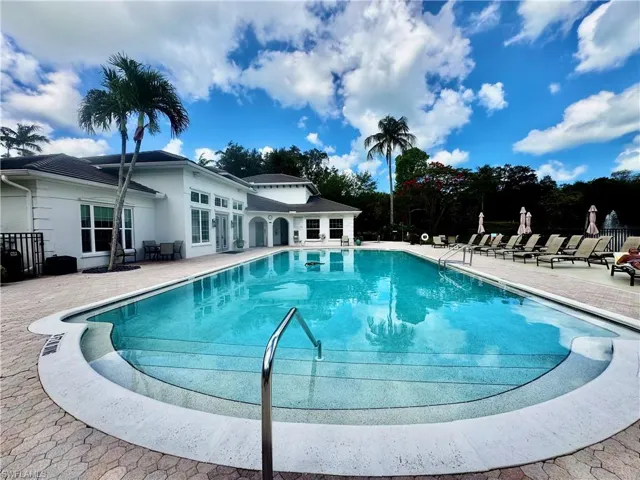 Expansive outdoor swimming pool with a paved deck
