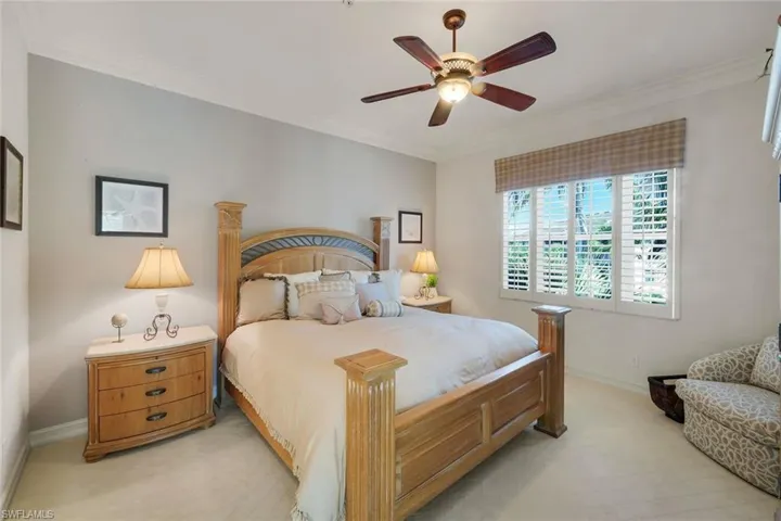 Bedroom featuring crown molding, neutral wall color, and carpeted flooring