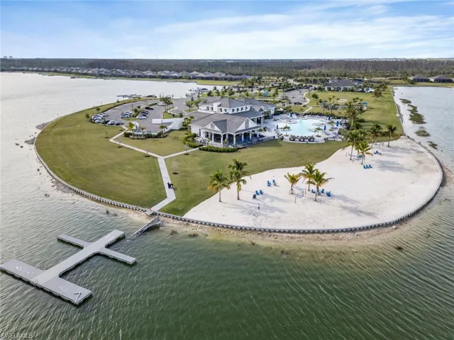 Private sand beach photo featuring the clubhouse in the background and the boat docks.