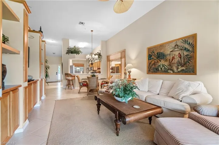 Tiled living room with a chandelier